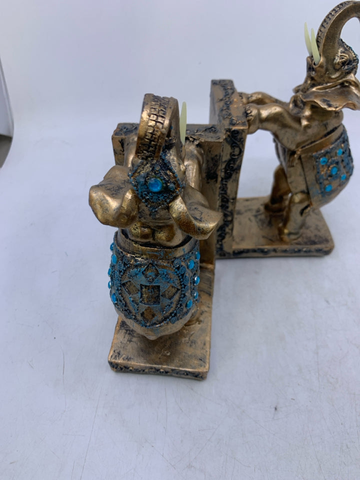 RESIN ELEPHANTS PAINTED GOLD W/ BLUE DETAILS.