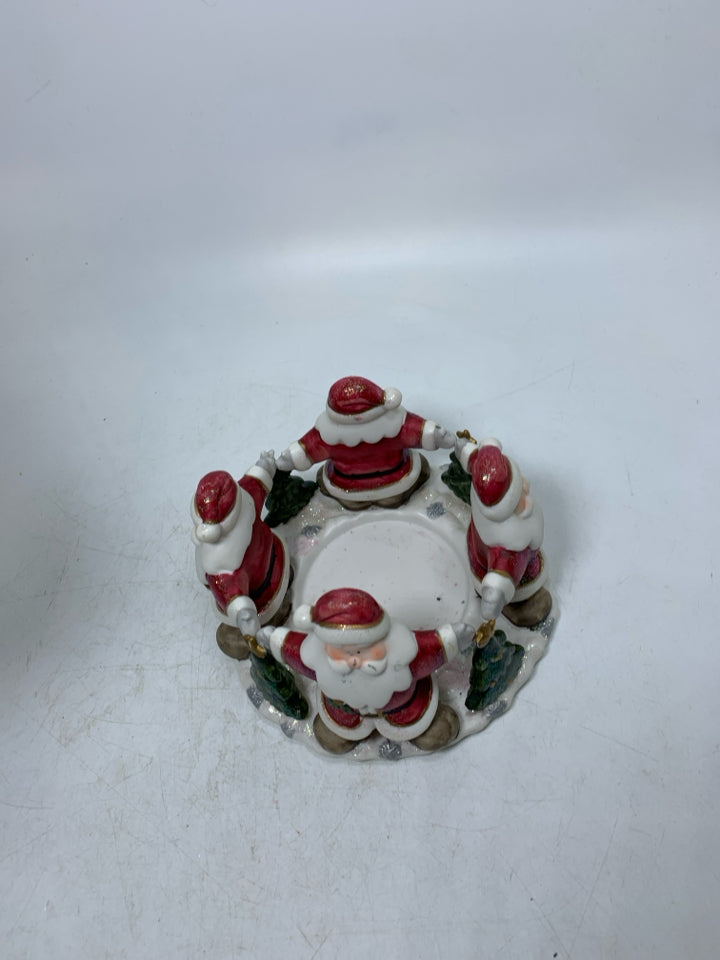 CERAMIC SANTA TOUCHING HANDS BASE W/ RED PILLAR CANDLE.
