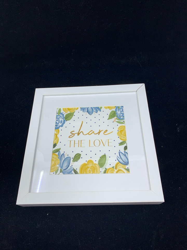 SHARE THE LOVE BLUE AND YELLOW FLORAL IN WHITE FRAME WALL HANGING.