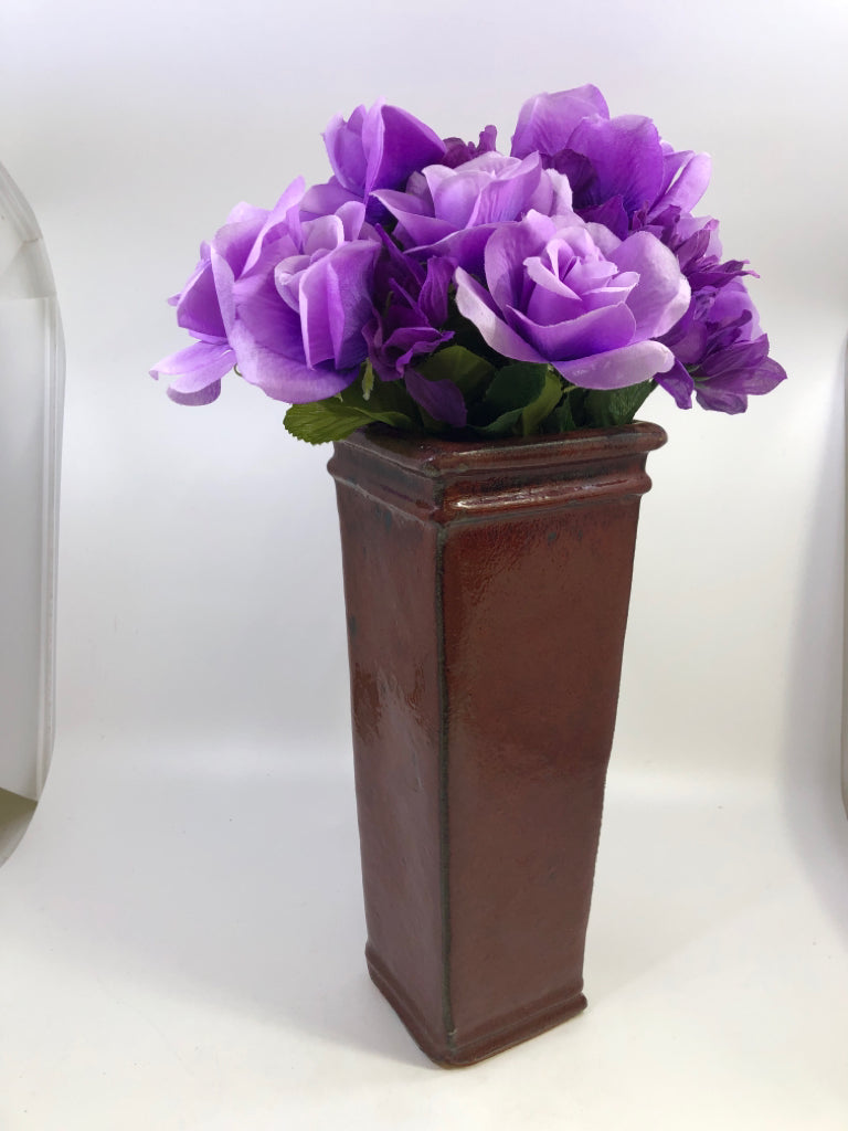 RED CERAMIC SQUARE VASE W/FAUX PURPLE FLOWERS.