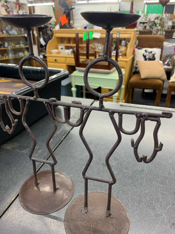 2 BROWN IRON MEN HOLDING FISH CANDLE STICK HOLDERS.