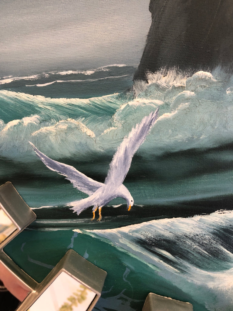 SEAGULL W/WAVES OIL PAINTING IN CIRCULAR REFLECTIVE FRAME.