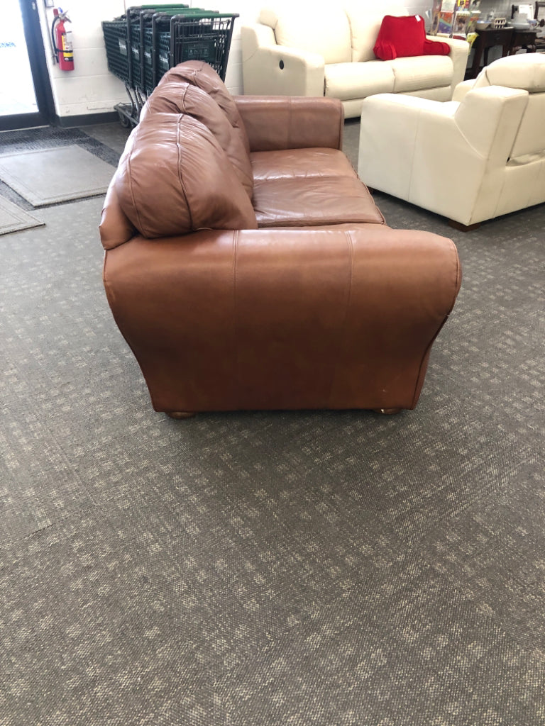 BROWN FAUX LEATHER COUCH.