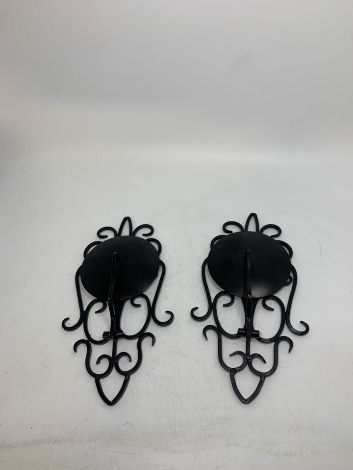 2 BLACK SCROLL FOLD DOWN PILLAR CANDLE HOLDERS.