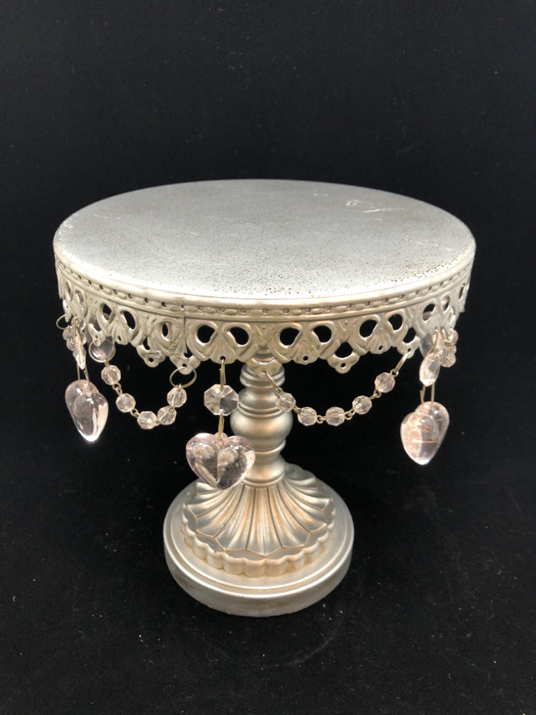 RAISED METAL CAKE STAND W/DANGLE HEART CHARMS.