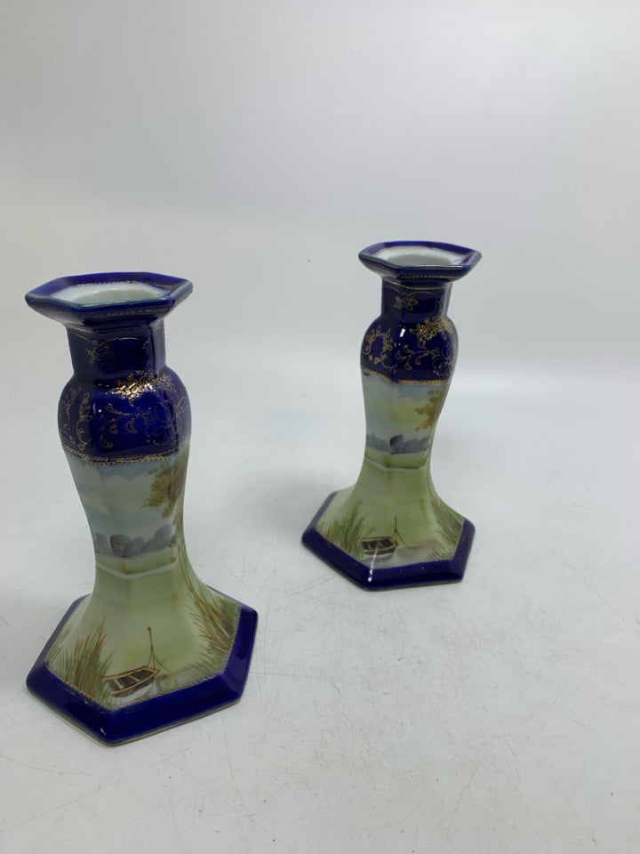 2 CERAMIC COBALT BLUE W/ SCENE TAPERED CANDLE HOLDERS.