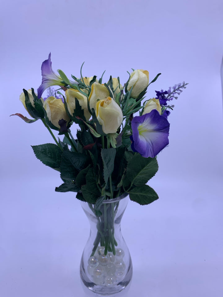 PURPLE AND YELLOW FLOWERS IN HOUR GLASS VASE.