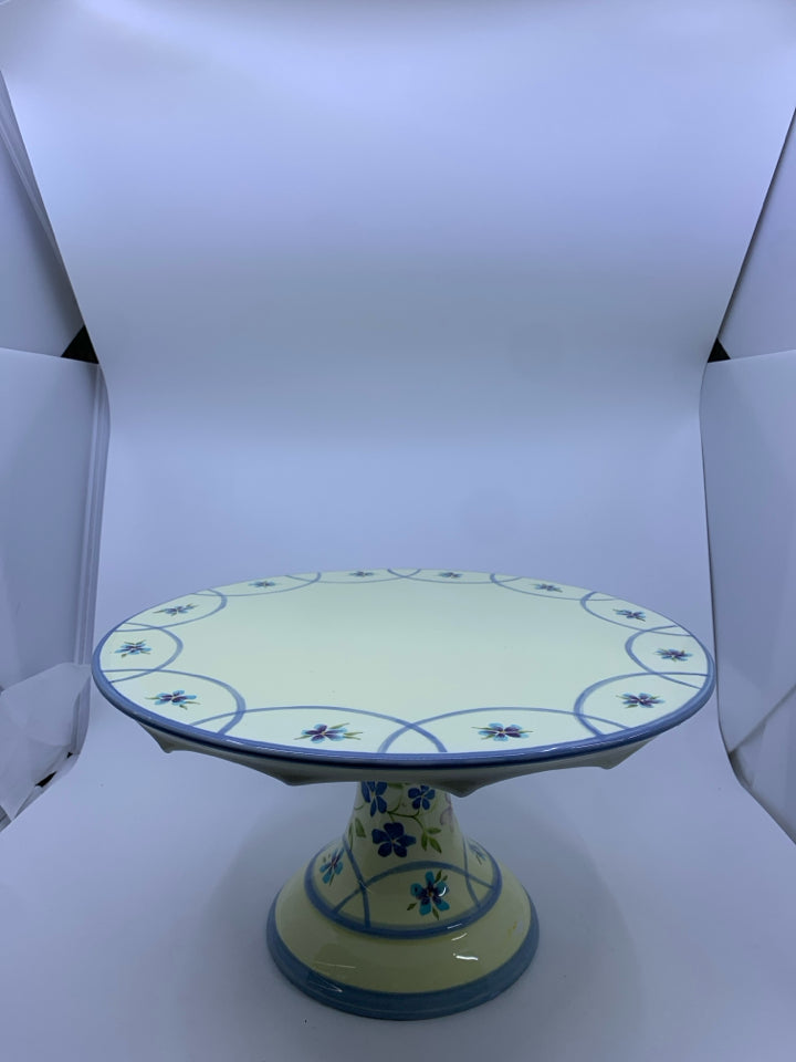 FOOTED CERAMIC YELLOW+BLUE CAKE STAND W/ FLOWERS.