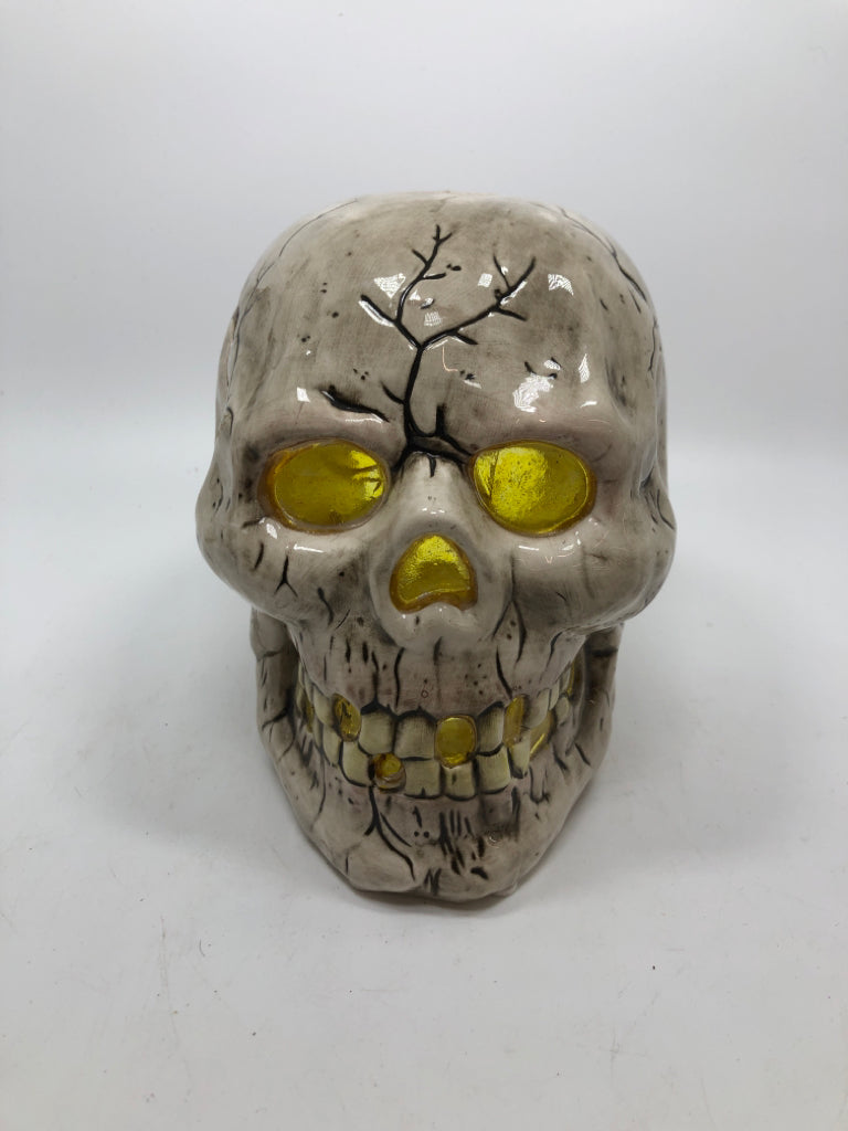 CERAMIC CRACKLE SKULL CANDLE HOLDER.