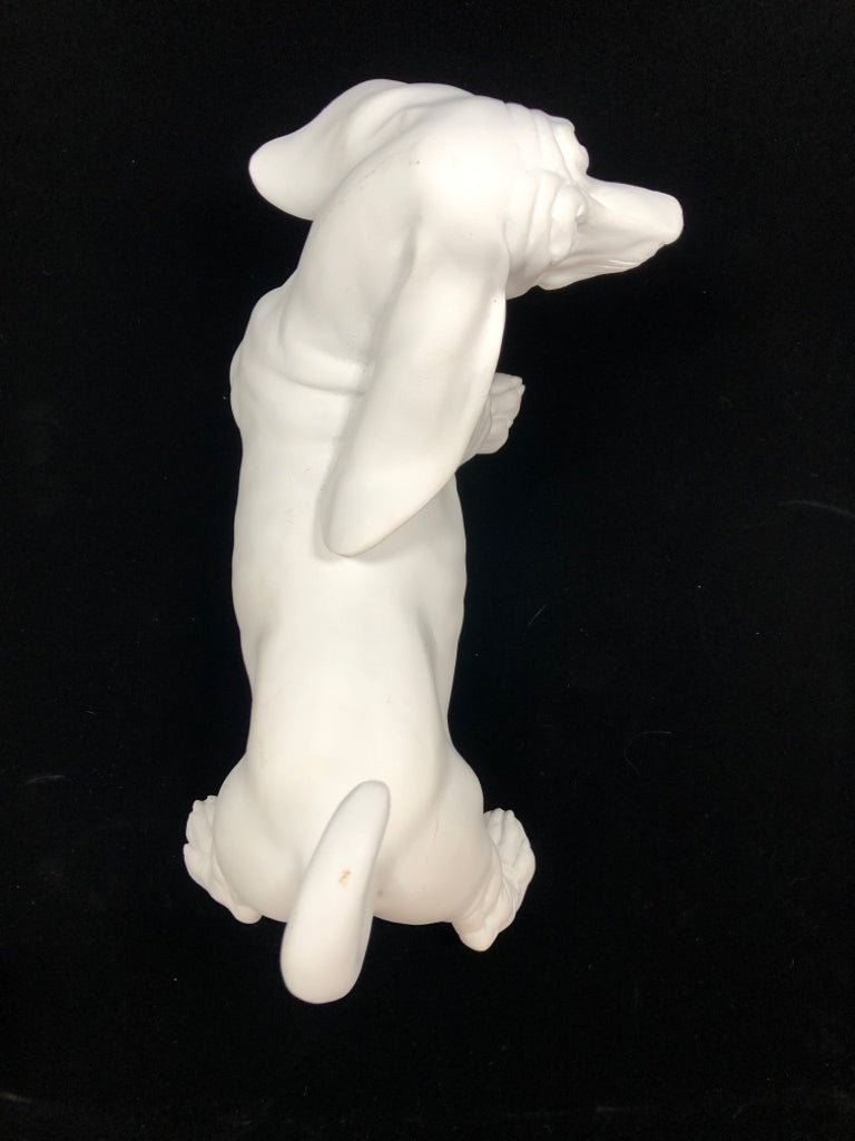 WHITE CERAMIC DOG FIGURINE.