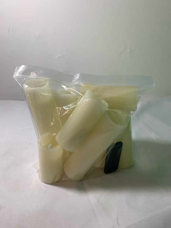 8 WHITE BATTERY OPERATED CANDLES WITH REMOTE.