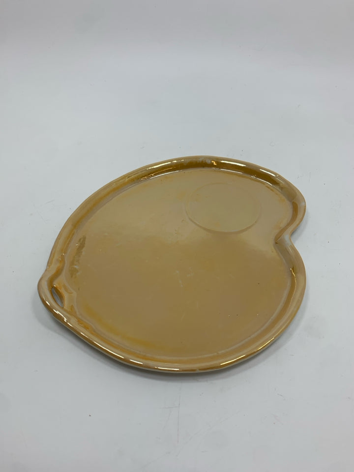 LAVENDER CANDLE CUP ON PEACH IRIDESCENT TRAY.