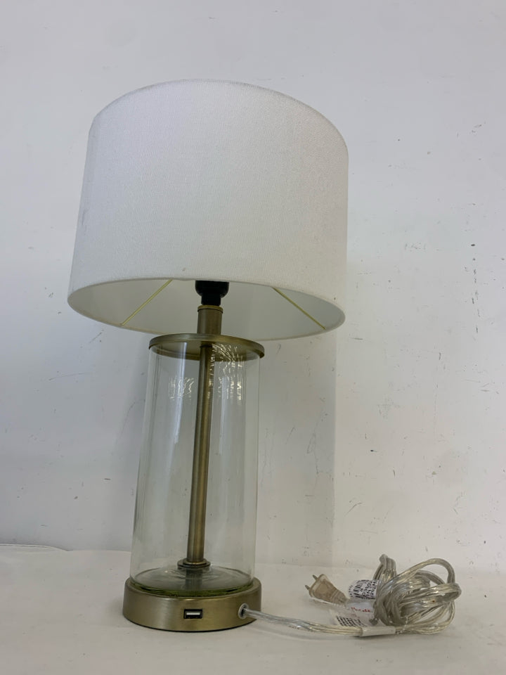 CLEAR GLASS BASE LAMP W WHITE SHADE.