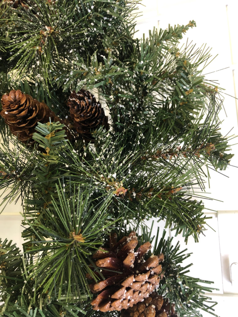PINE WREATH W/PINECONES AND FAUX SNOW.