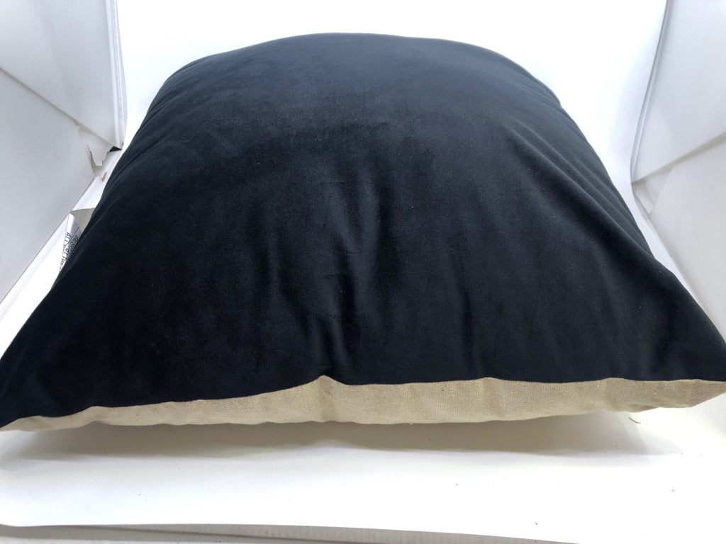 BLACK AND TAN PILLOW.