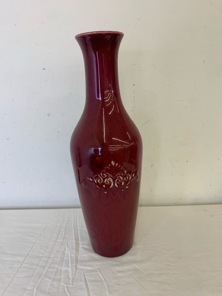 LARGE RED FLOOR VASE W EMBOSSED SCROLL DETAIL.