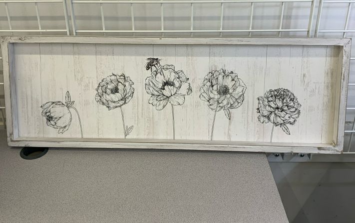 BEE ON FLOWER IN WHITE WOOD FRAME.