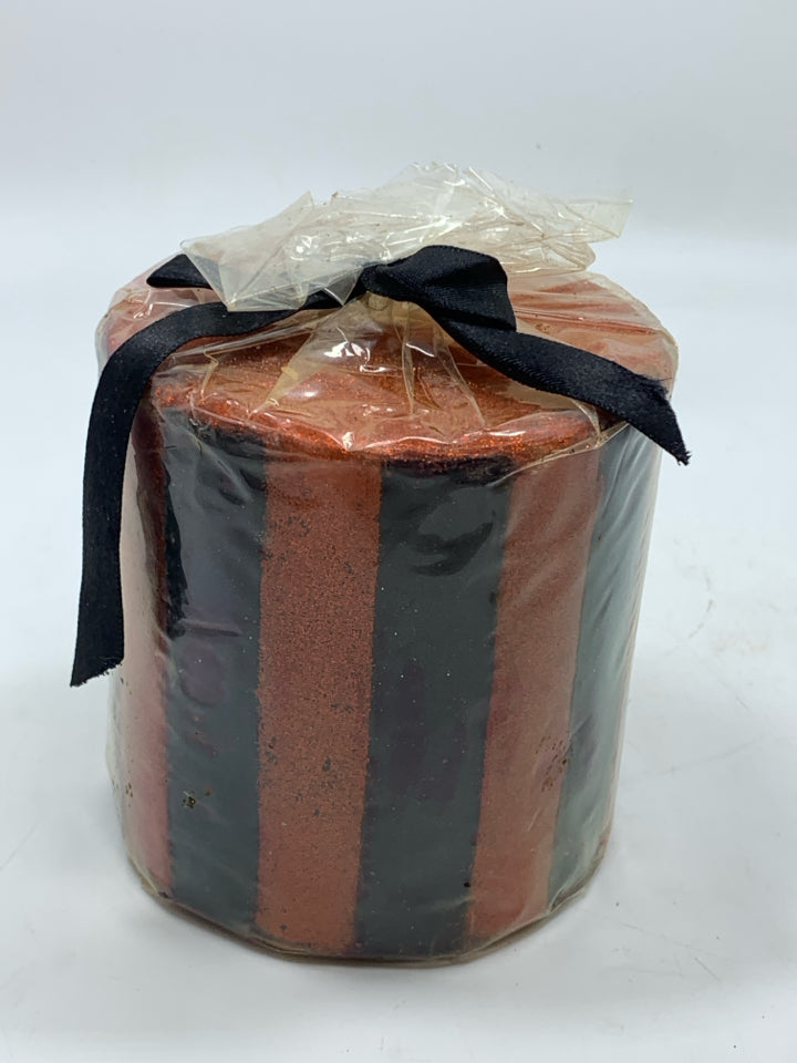 BLACK & ORANGE STRIPED CANDLE.
