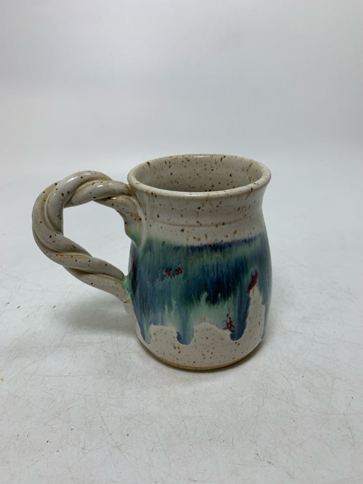 WHITE SPECKLED POTTERY MUG W/ TWISTED HANDLE BLUE DRIPS.
