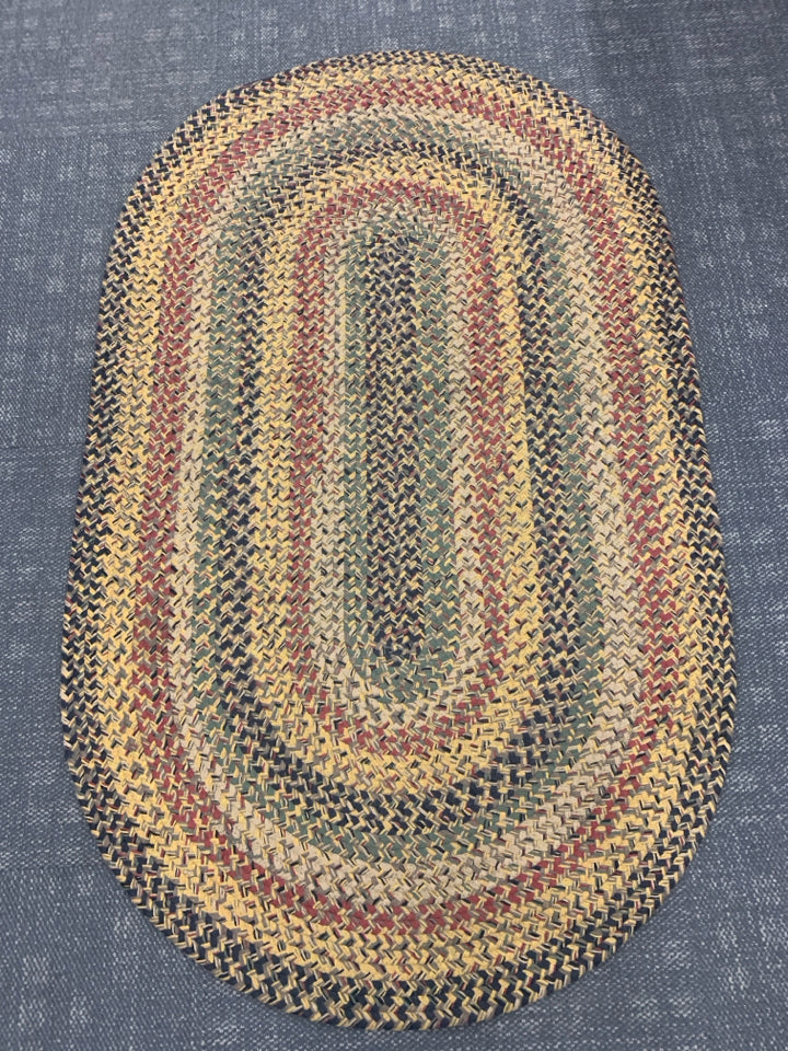 OVAL BRAIDED RUG.