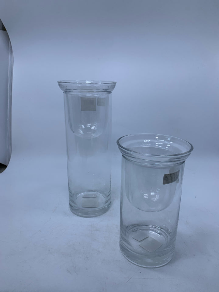 2 CLEAR GLASS CYLINDERS W/ DROP IN TEA LIGHTS.