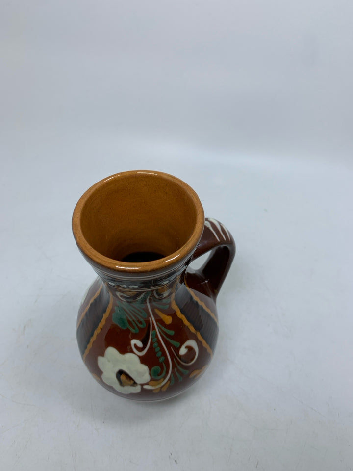 DARK BROWN PITCHER W/ DETAILED FLORAL DESIGN TERRA COTTA.