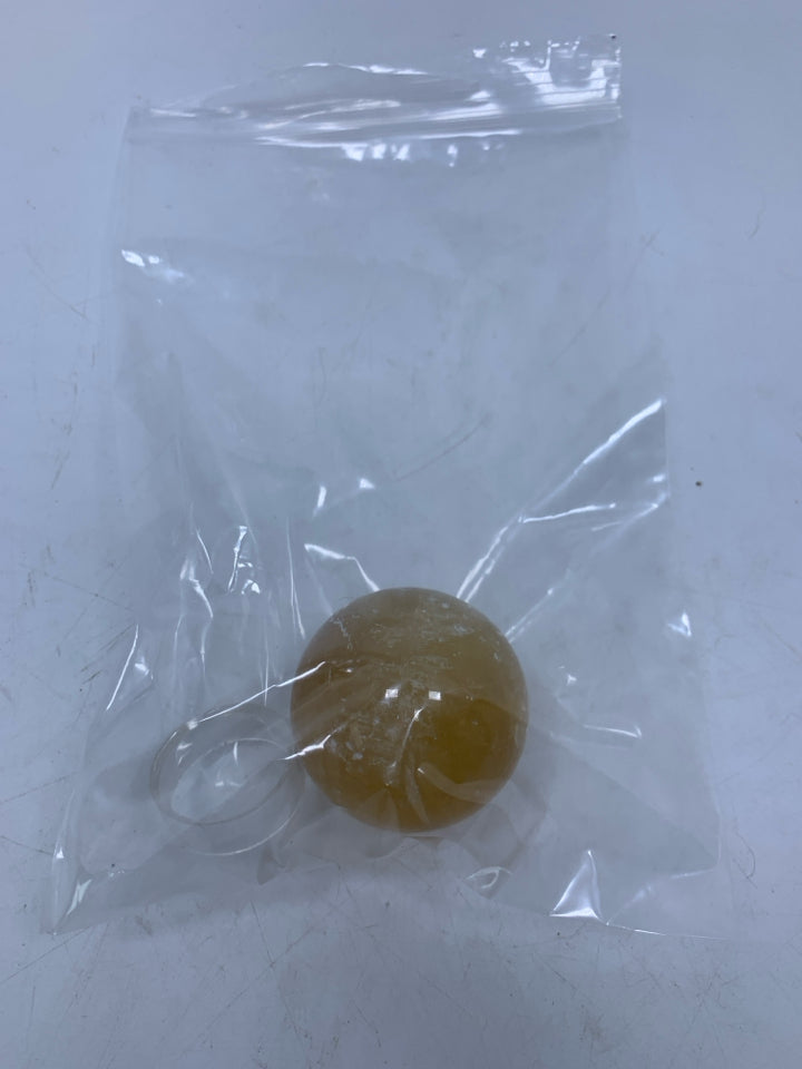 YELLOW STONE SPHERE W/ STAND IN BAG.