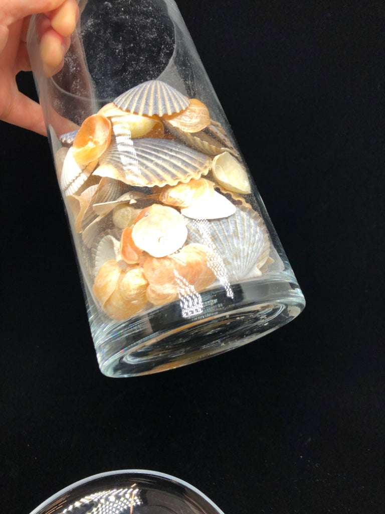 SEASHELL FILLED GLASS CANDLE HOLDER.