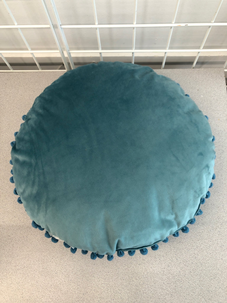 ROUND BLUE PILLOW W/POM POMS.