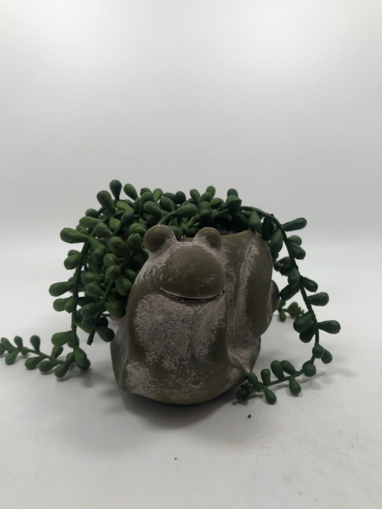 FAUX GREENERY IN SNAIL PLANTER.