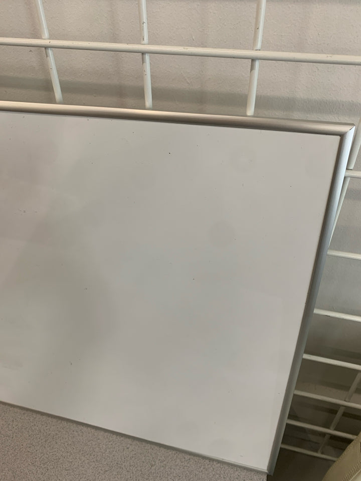 WHITE DRY ERASE BOARD.