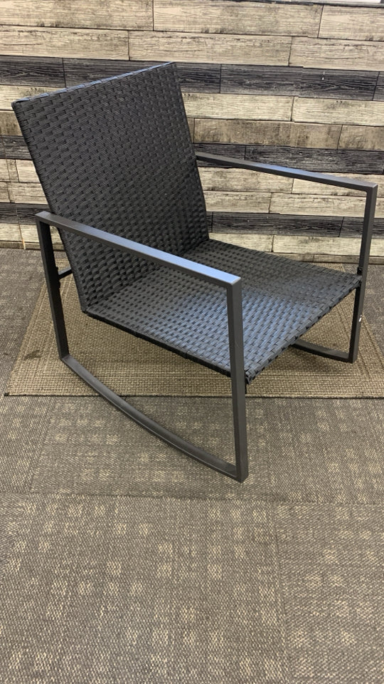 BLACK WICKER OUTDOOR ROCKING CHAIR.
