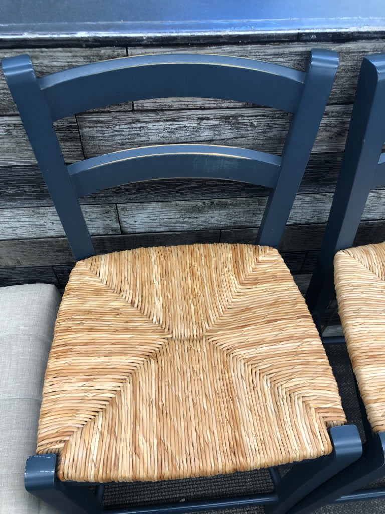 2 BLUE WOOD BAR STOOLS W/ WICKER SEAT.