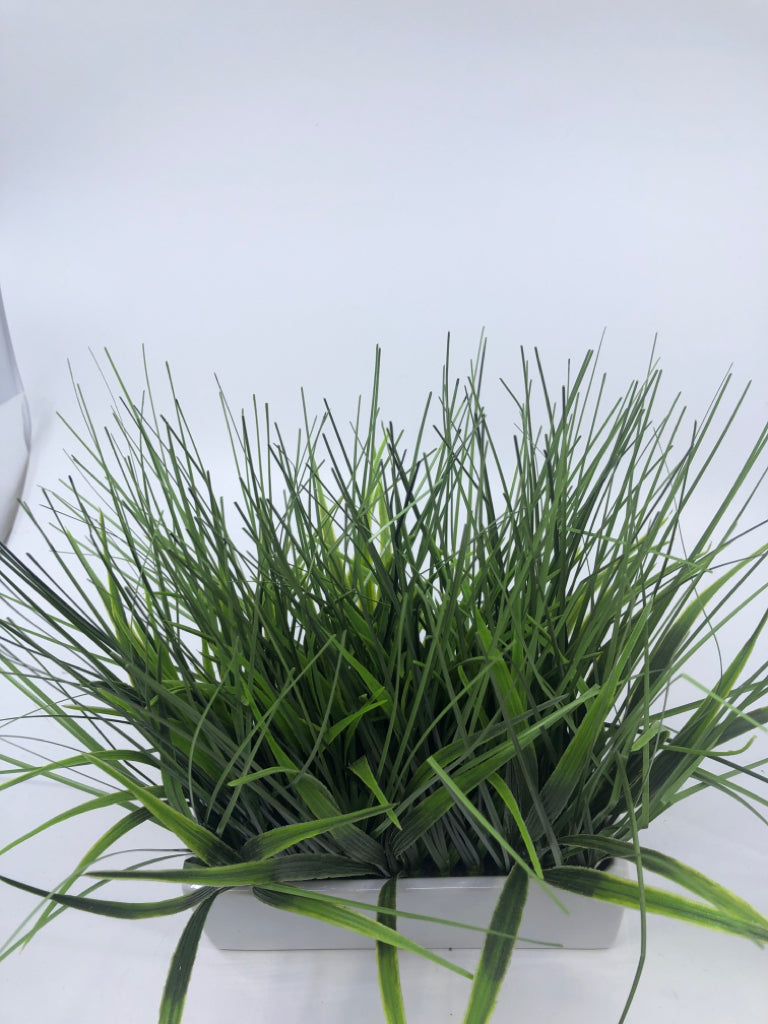 FAUX GRASS IN WHITE PLANTER.