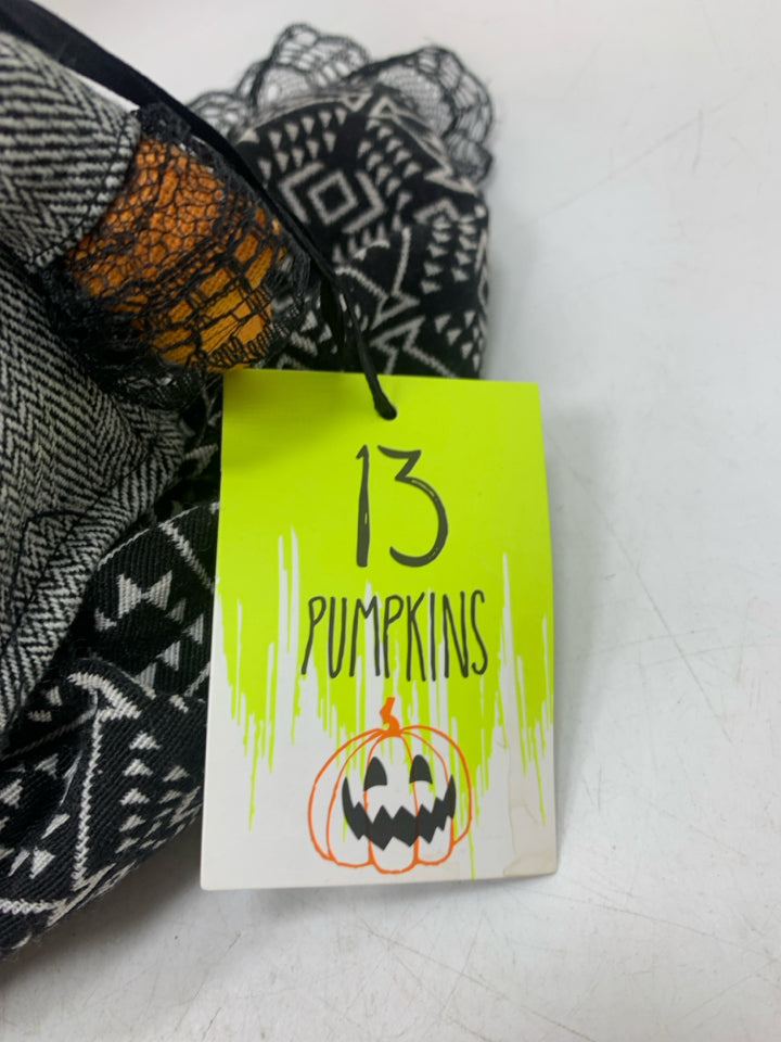 PLUSH PUMPKIN DOLL IN BLACK DRESS.