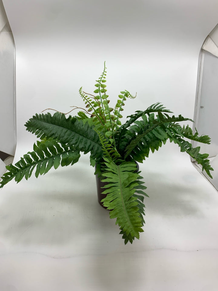 FAUX FERN IN BROWN CERAMIC POT.
