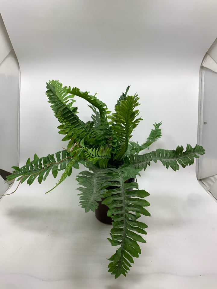 FAUX FERN IN BROWN CERAMIC POT.