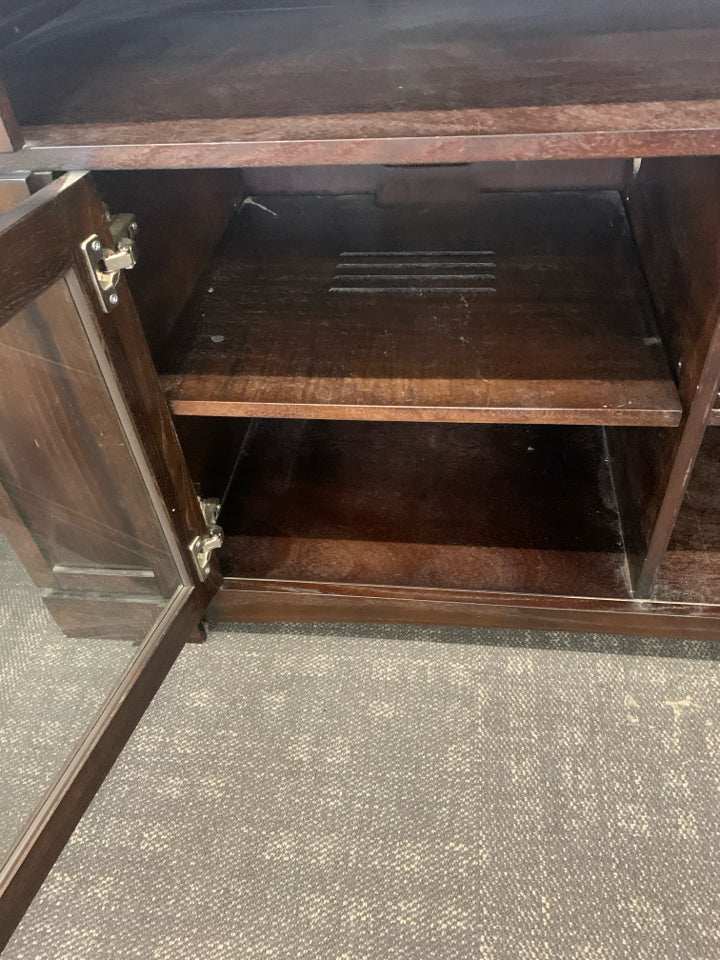 HEAVY DARK WOOD AND GLASS ENTERTAINMENT CENTER WITH SHELF AND CABINET STORAGE.