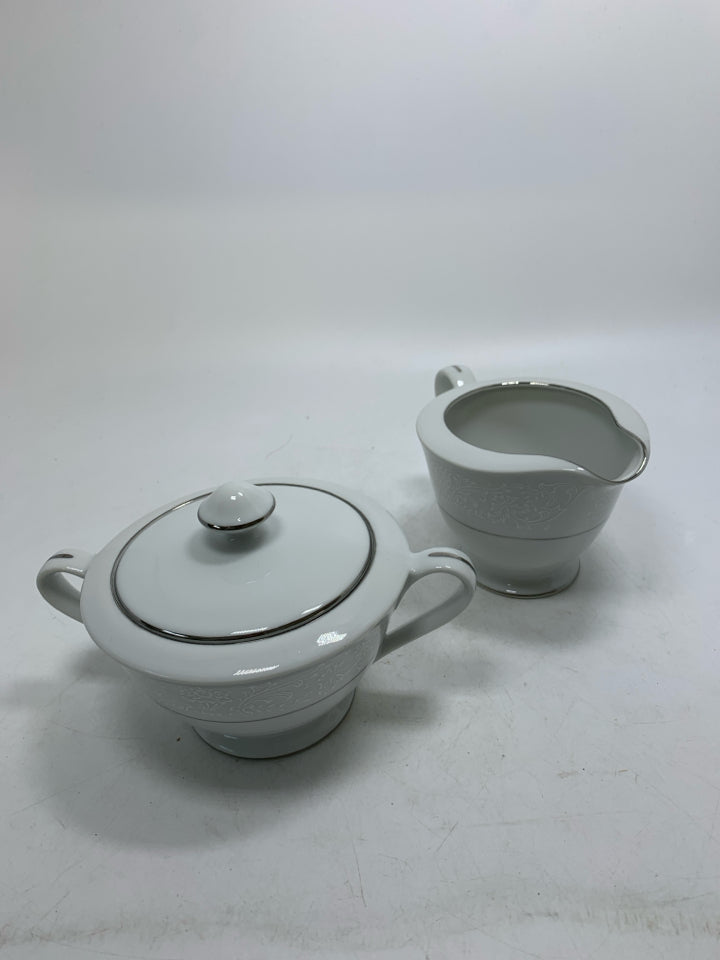FOOTED WHITE LACE PORCELAIN CREAM/SUGAR SET W/ SILVER DETAILED.