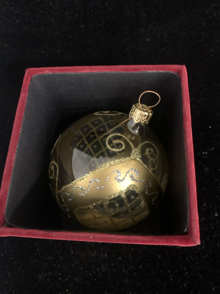 GOLD ACCENT GLASS ORNAMENT IN RED BOX.