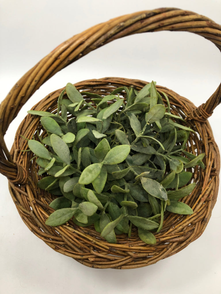FAUX GREENERY IN WICKER BASKET.