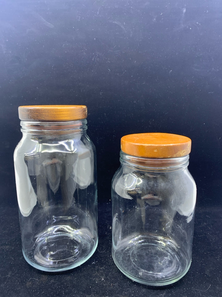 2 GLASS WOOD TOP CANISTERS.