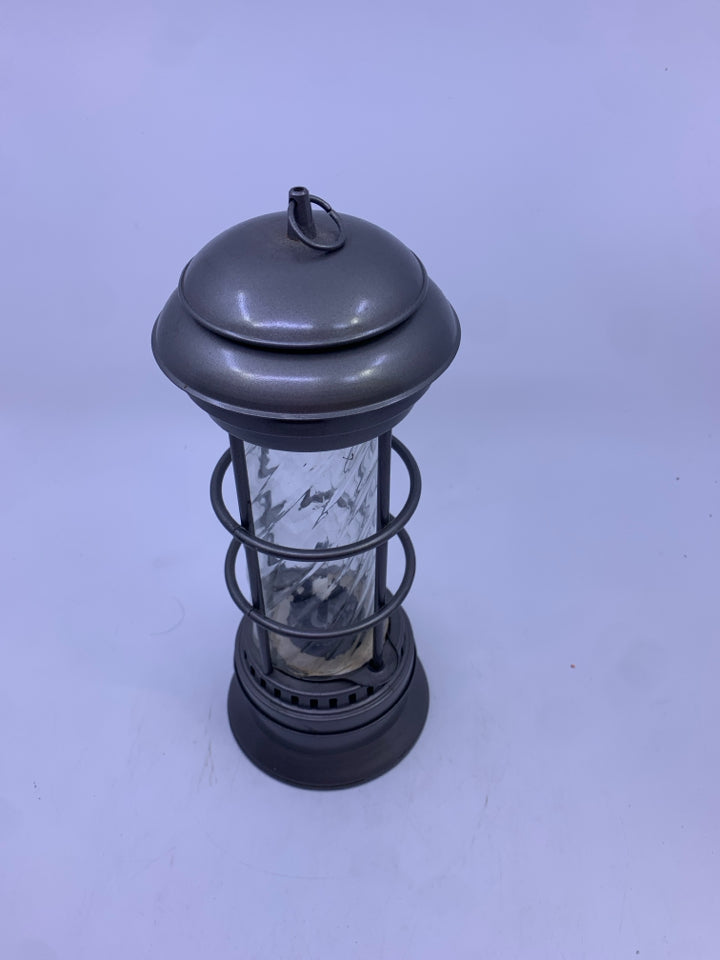 GREY METAL OIL LANTERN W/ GLASS PANE.