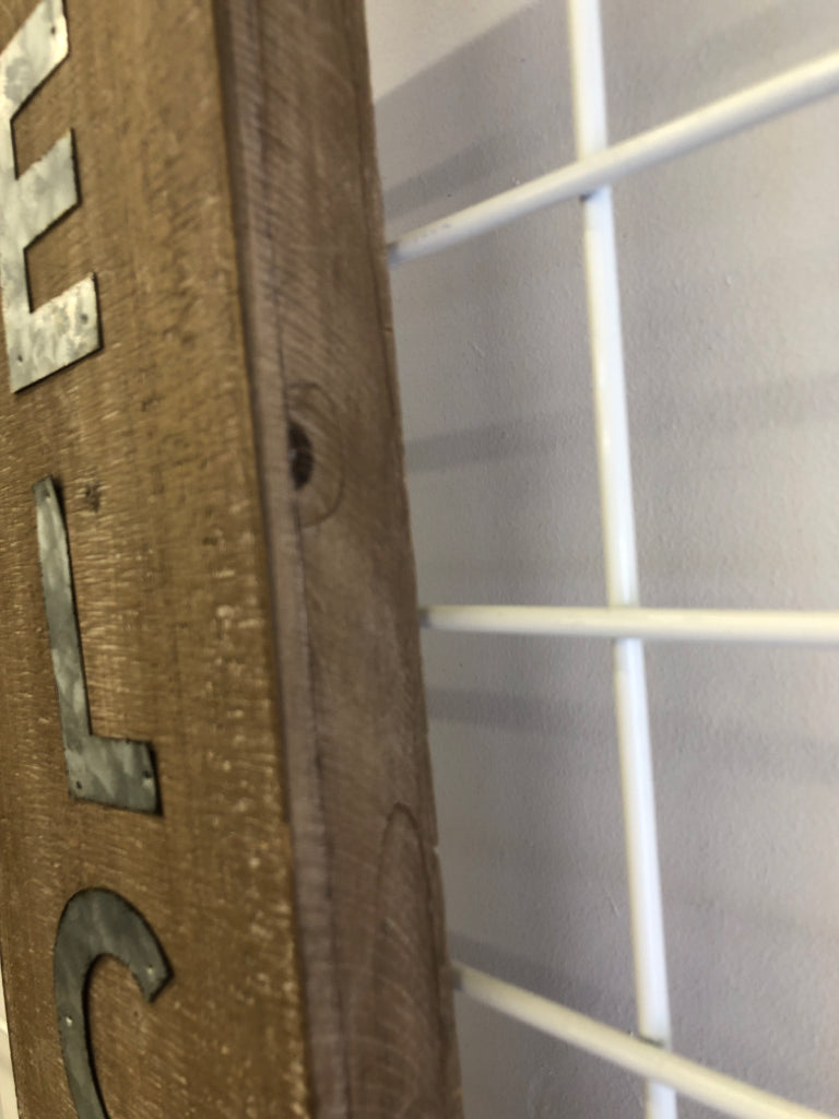 METAL "WELCOME" ON WOOD WALL/STANDING.