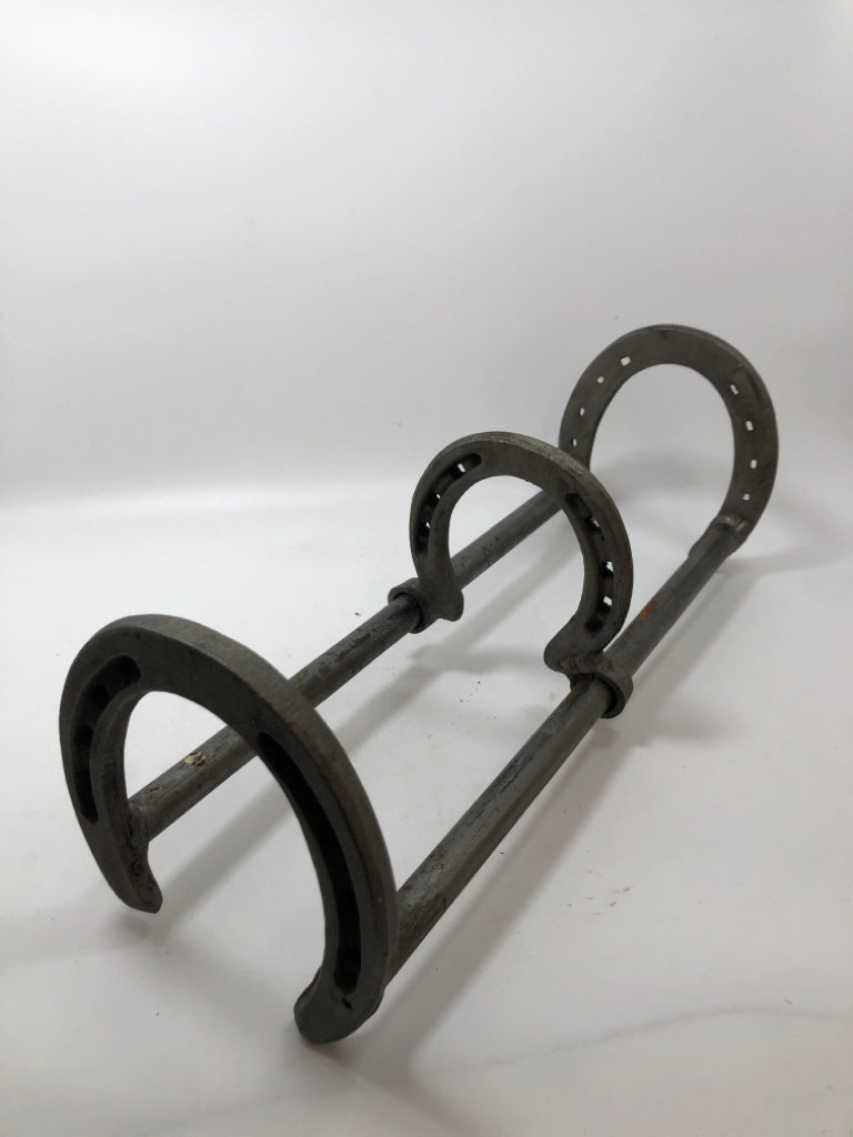 SLIDING HORSESHOE METAL BOOK HOLDER.