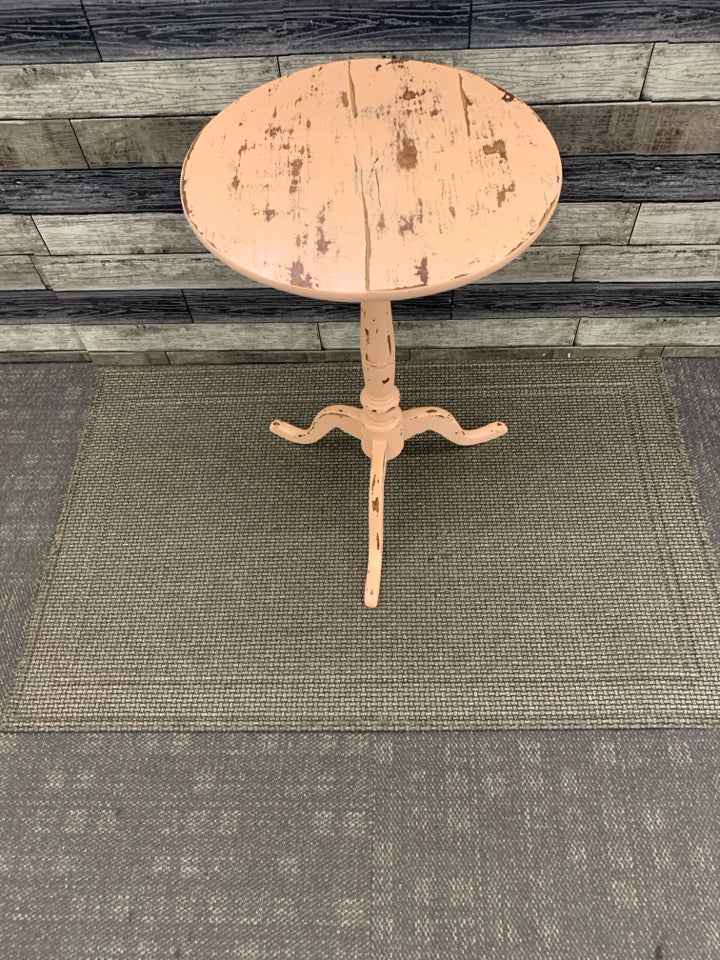 DISTRESSED PEACH AND WOOD ROUND SIDE TABLE.