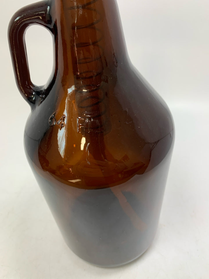 DARK BROWN GLASS 64 OZ JUG W/ PLASTIC PUMP.
