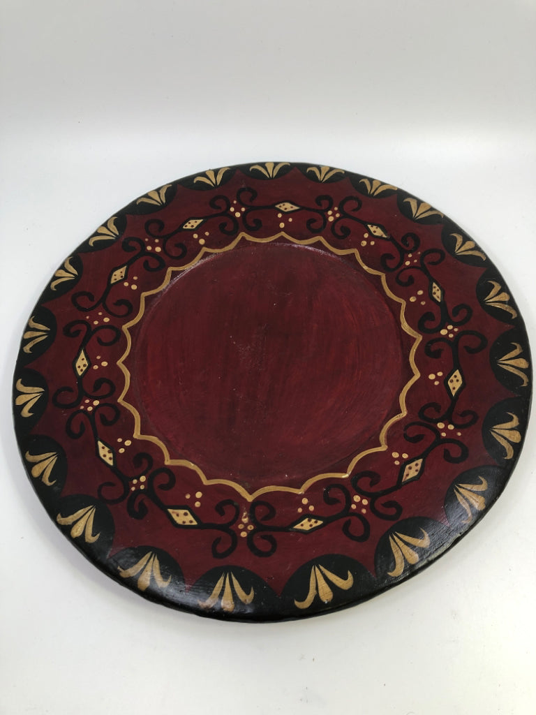 PRIMITIVE WOOD DECORATIVE PLATE RED W/GOLD AND BLACK ACCENTS.