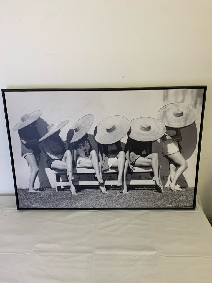 LADIES IN SUN HATS ON CHAIRS BLACK AND WHITE WALL HANGING.