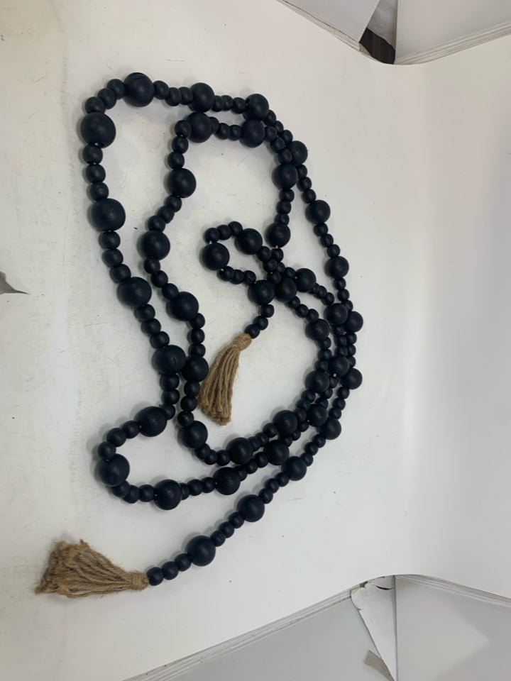 BLACK BEADS W/ TASSELS GARLAND.
